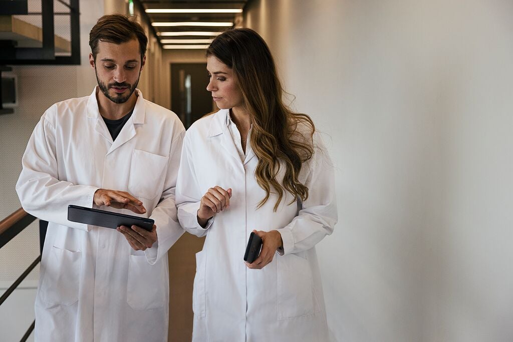 Two medical workers in white lab coats