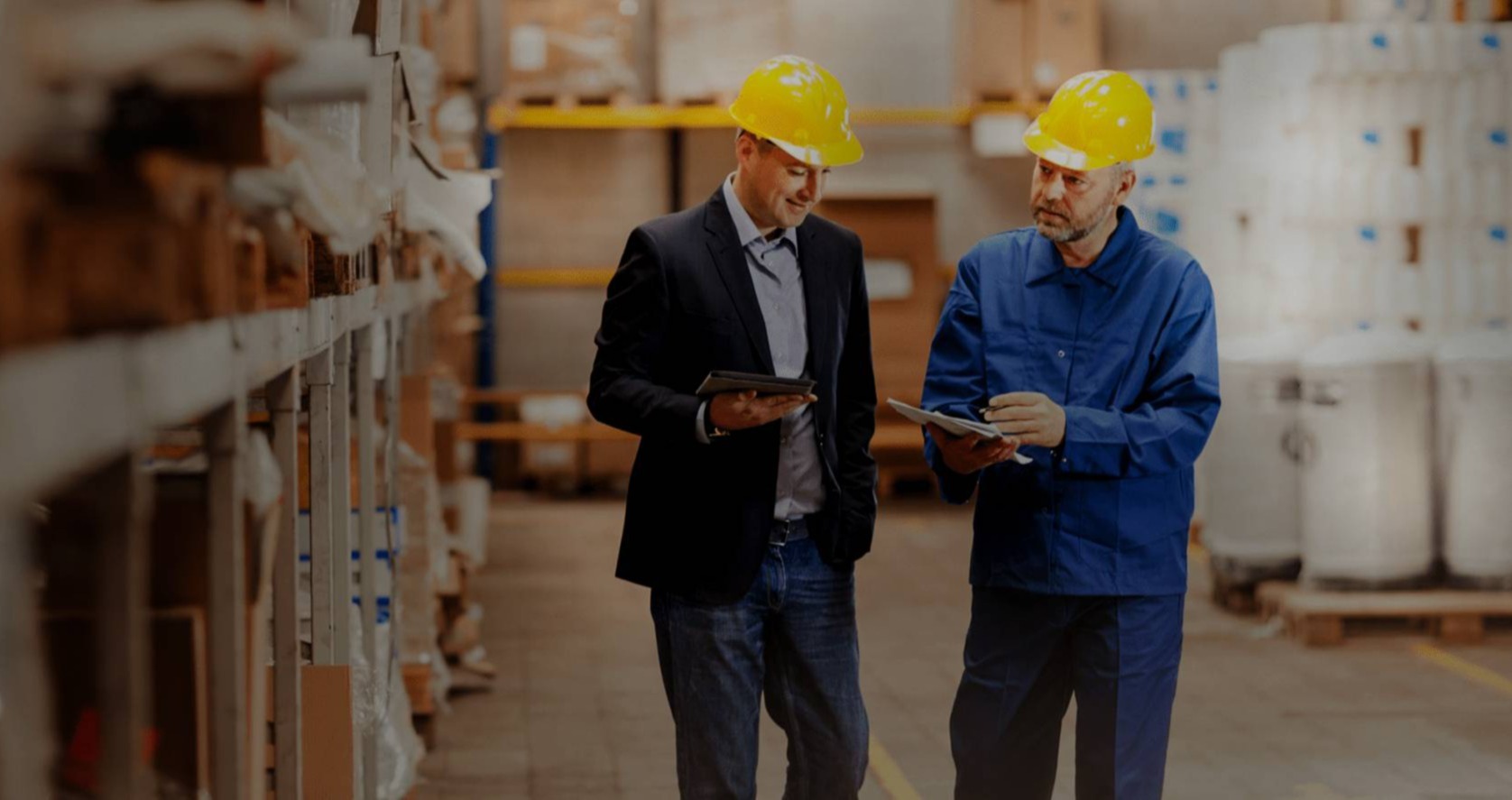 two workers in warehouse with yellow caps