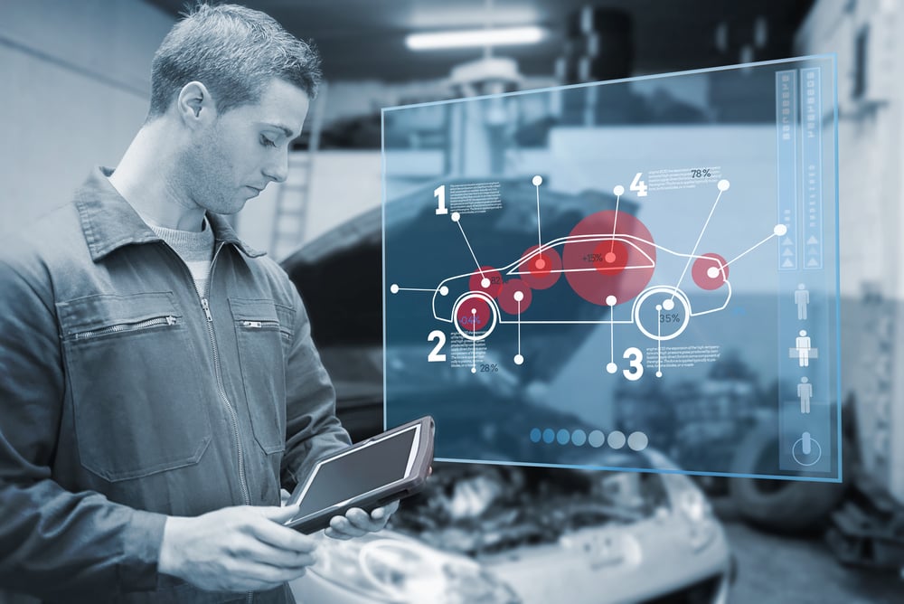 Mechanic using tablet and futuristic interface with diagram  in black and white